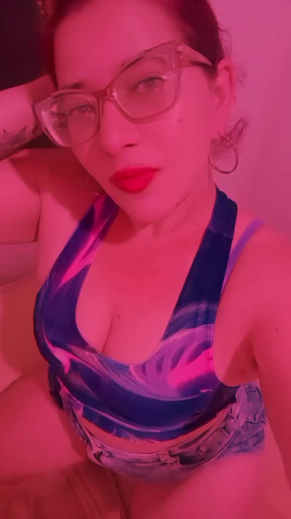 Gostosa sensualizando com seios, óculos e batom vermelho